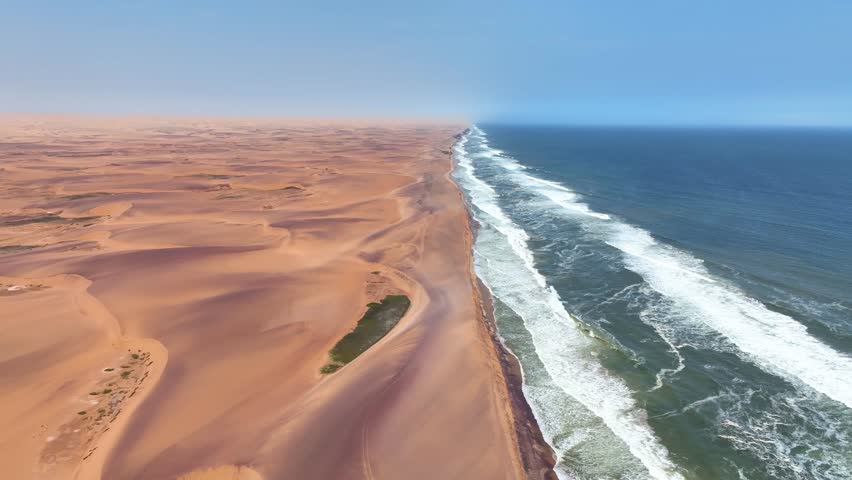 Aerial of the desert sand dunes plunging into the Atlantic Ocean, Iona National Park, Angola, Africa Royalty-Free Stock Footage #3437004951