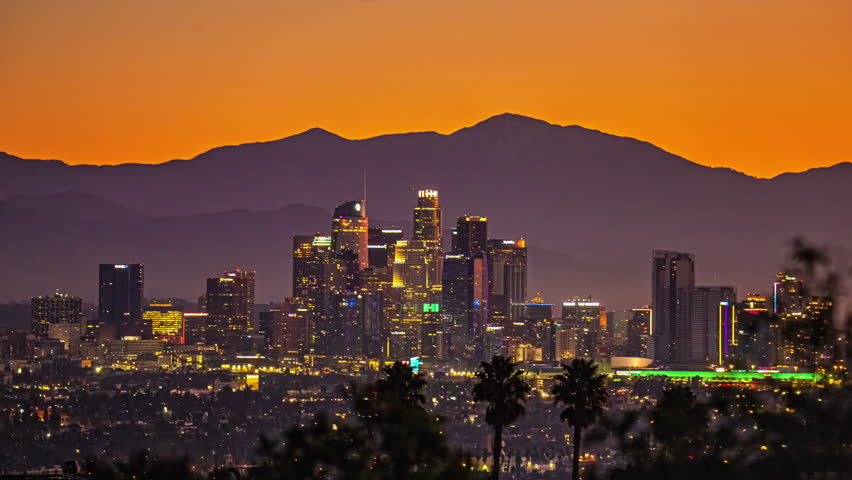 Los Angeles city skyline with mountains in the background sunrise dawn light time lapse