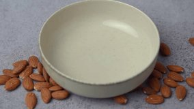 Fresh almond flour in a  bowl and almonds. Gluten free food concept.
