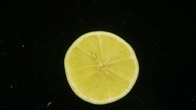 A round piece of lemon falls beautifully into the water. This gives the water a sour taste. High quality 4k footage - Powered by Shutterstock - Get 15% off with code: PIKWIZARD15
