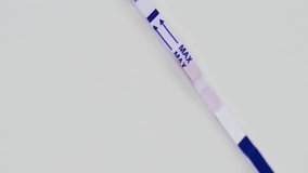 Positive home express pregnancy test, on a white table. Vertical video. 
