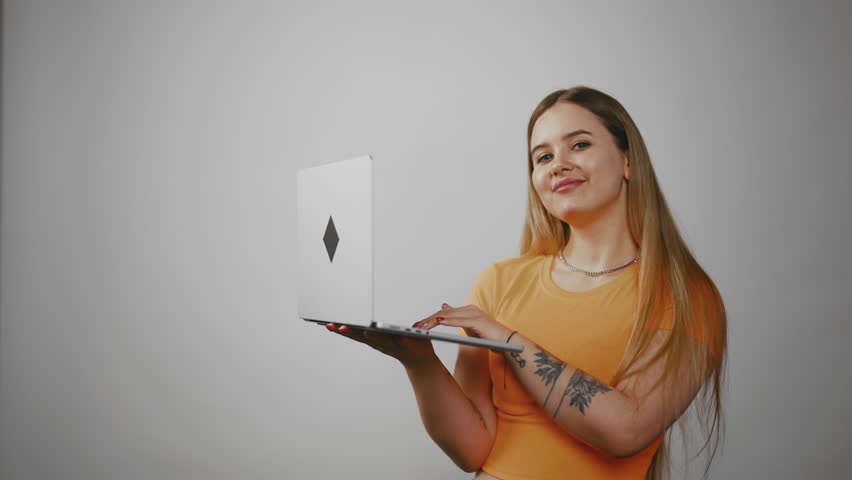 Young smiling woman typing on laptop. Emotional young freelance business lady working, watching webinar, using online app, holding computer at home. Online job, administration manager concept. Royalty-Free Stock Footage #3437070057