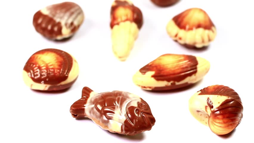 Closeup of fish shaped chocolates. Camera panning from bottom to top. 