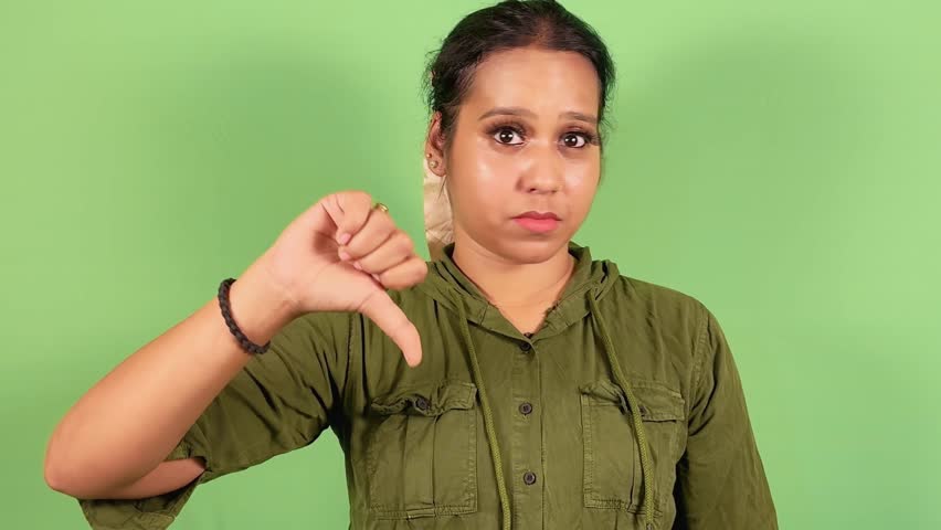 Women giving thumbs down gesture, on green screen background, expressing disapproval or negative feedback, Asian, female, Indian, Women not satisfied with performance, Not happy with service, Negative Royalty-Free Stock Footage #3437099307