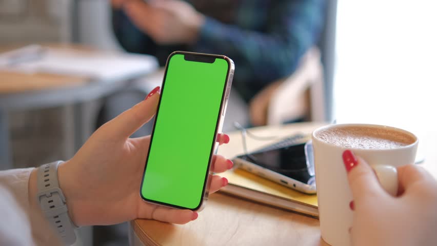 Businesswoman, hands or green screen phone in coffee shop, restaurant or cafe on social media app or calendar management. worker employee or mobile technology mockup of office logo on lunch break 4K