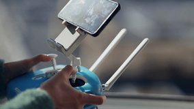 UAV Drone Remote Control. Copter Remote Control. Pilot Controlling Drone Use Joystick. Modern Technology Video Shooting Camera. Drone Controller. Pilot Fly On UAV. Aerial Device UAV Drone Controller  - Powered by Shutterstock - Get 15% off with code: PIKWIZARD15