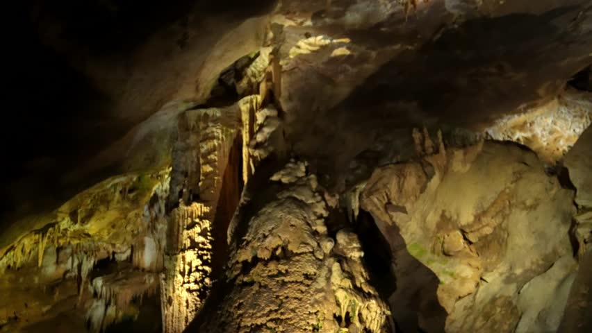 Prometheus (Kumistavi) cave near Tskaltubo and Kutaisi. Imereti Region. Natural monument with hanging stone curtains, stalactites and stalagmites, colorful illuminated rock formations.