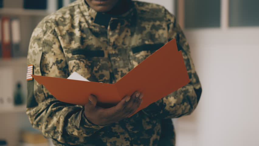 Military reconnaissance officer reading classified documents, secret information