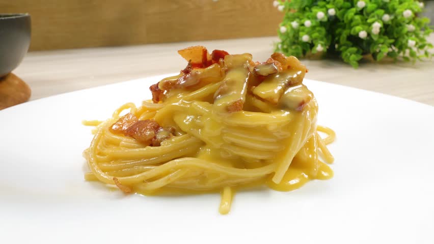 Spaghetti carbonara. Italian pasta with parmesan, cured pork jowls and eggs. Royalty-Free Stock Footage #3437192713