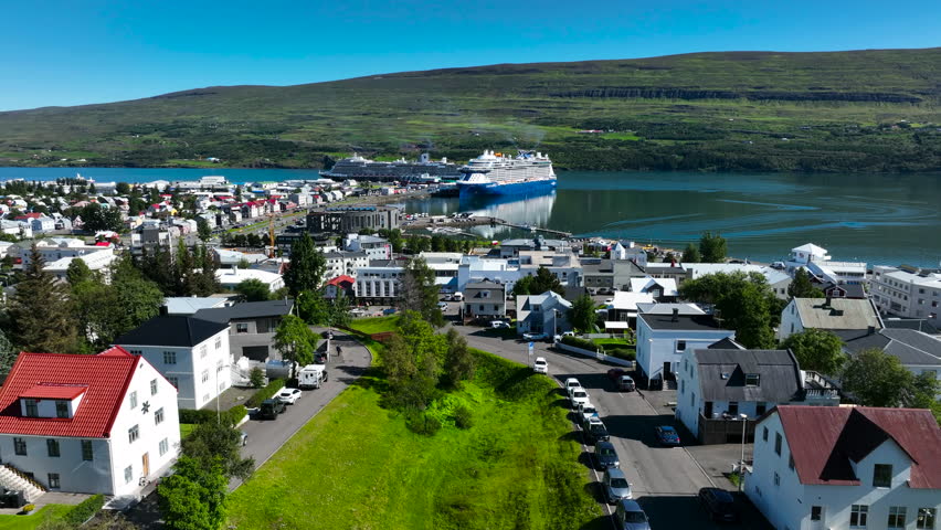 A cruise ship docks in the port of Akureyri in Iceland. Cruise on the Atlantic Ocean. Port in Iceland. Akureyri City in Iceland