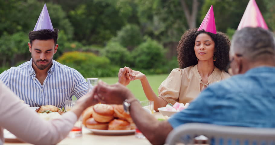 People, hand holding and pray at table for food as family or meal gratitude or religion, support or thankful. Men, women and outdoor gathering for god at social event or holy grace, together or faith