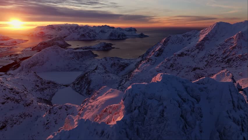 Drone view of Snowy Mountain Range Silhouette Sunrise Aerial View. Landscape Dawn Sunlight Mountainous in Norway