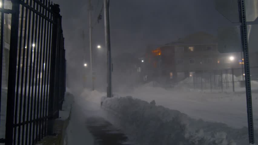 Blizzard, strong wind, snow, against the background of houses and empty streets at night in a snow storm, the city of Dartmouth, Canada. Snow covers the streets, houses and cars overnight. 2024 Royalty-Free Stock Footage #3437339577
