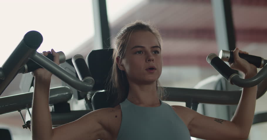 Woman taking weight lifting in sport club. Fitness girl having sport training in fitness gym. Sporty young woman training back muscles in gym. Female hands taking bodybuilding dumbbells in gym club.4K Royalty-Free Stock Footage #3437364717