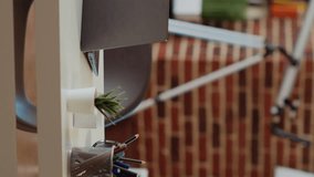 Vertical video Laptop on desk next to mini plants in empty apartment lit by sunlight, TV left open in background, panning shot. Notebook device in elegant living room with warm interior decor - Powered by Shutterstock - Get 15% off with code: PIKWIZARD15