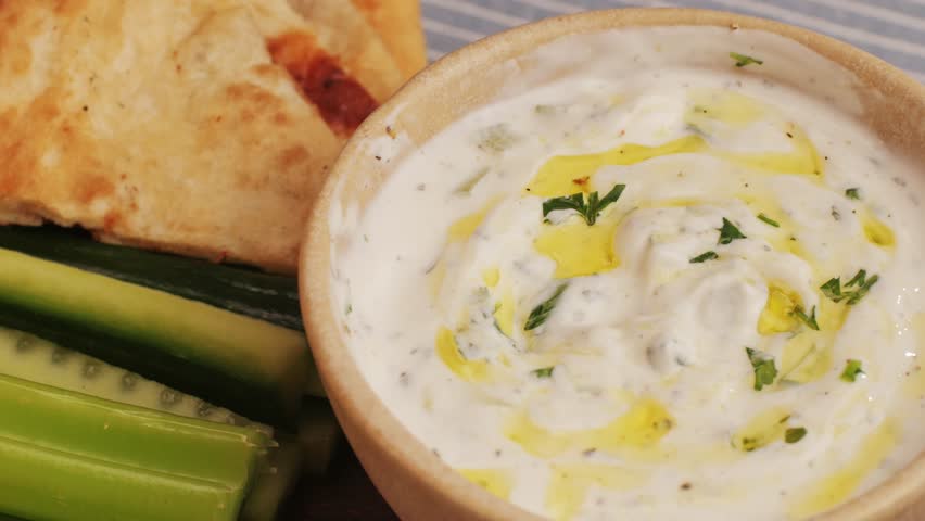 Greek Tzatziki sauce of salted strained yogurt or diluted yogurt mixed with cucumbers and mint, garlic, salt, olive oil on top.