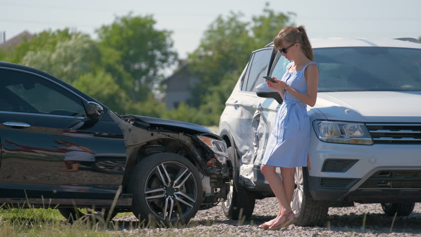 Stressed woman driver talking on mobile phone on street side calling for emergency service after car accident. Road safety and insurance concept Royalty-Free Stock Footage #3437386531