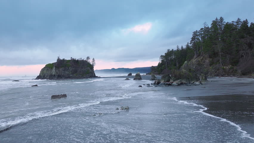 Washington State, aerial of cinematic Olympic National Park. Dramatic sea stacks on rocky Ruby Beach along the Olympic coastline on moody overcast evening. Ruby Beach on West Coast of Northern America