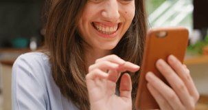 Happy woman, phone and wave for video call, communication or conversation and networking at home. Closeup of female person smile, blowing kiss or hello on technology for friendly discussion at house