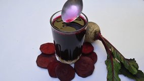 Beet juice. Healthy Beetroot juice in a glass and fresh beetroot on a table. Healthy dieting drink. Fresh beet juice of organic vegetable in domestic. Slow motion video.