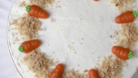 Homemade Easter carrot cake made with walnuts, iced with cream cheese. Sweet dessert.  Plate with delicious carrot cake
