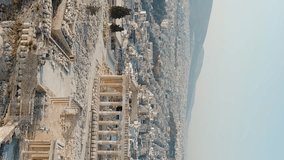 Vertical video. Athens, Greece. Acropolis of Athens in the light of the morning sun. Summer, Aerial View