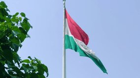 The national flag of Tajikistan on the flagpole in Dushanbe. Asia. Video with the flag of Tajikistan waving, flag on a pole, horizontal, rectangular, raising the flag. 4K
