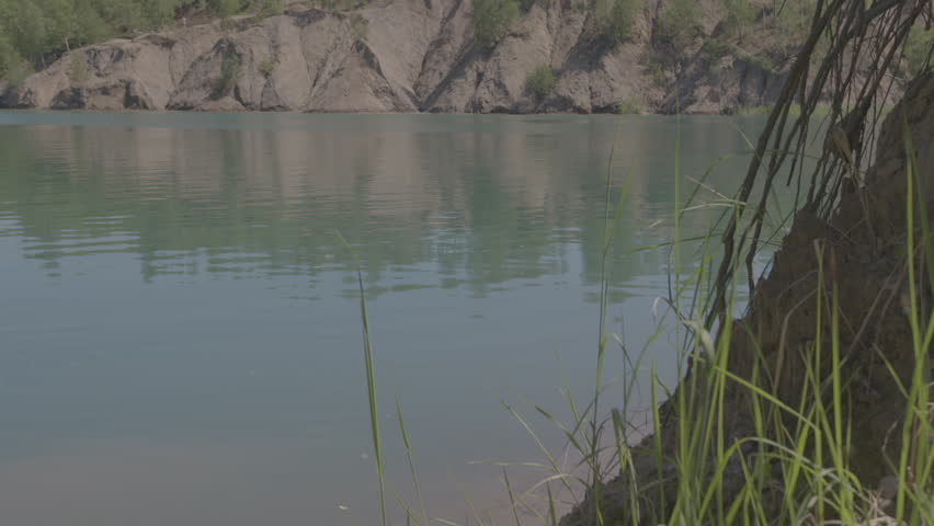 A man in a medieval villager costume falls into a pond, river or lake