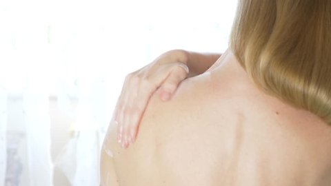 Shoulder and woman back body lotion spreading slow motion close-up, 4k
