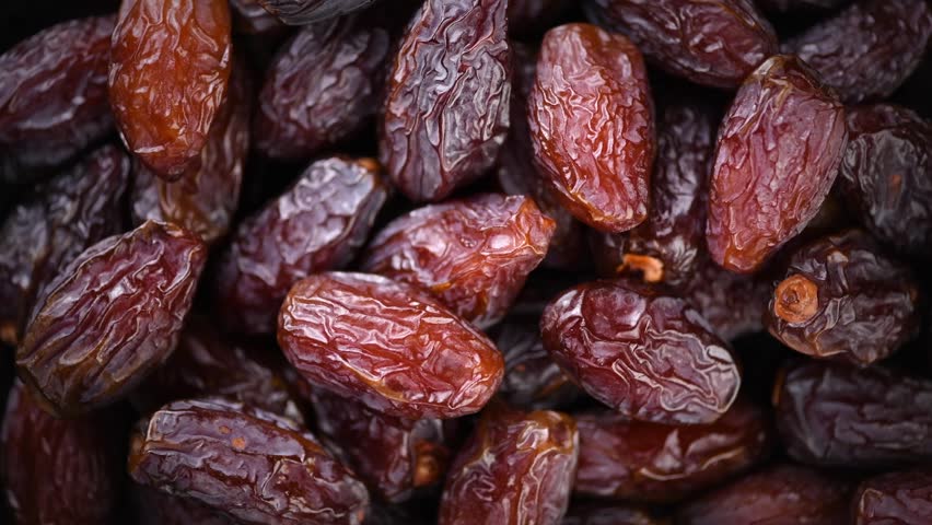 Date fruits. Dates fruit close up design background. Heap of Medjool dates close up, macro shot. Dried fruits, healthy vegan food backdrop rotating Royalty-Free Stock Footage #3437733011
