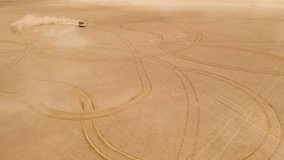 Drone flight over white car dune drifting in desert, sending sand spread into the air. Namibia, Africa. Aerial 4k video footage