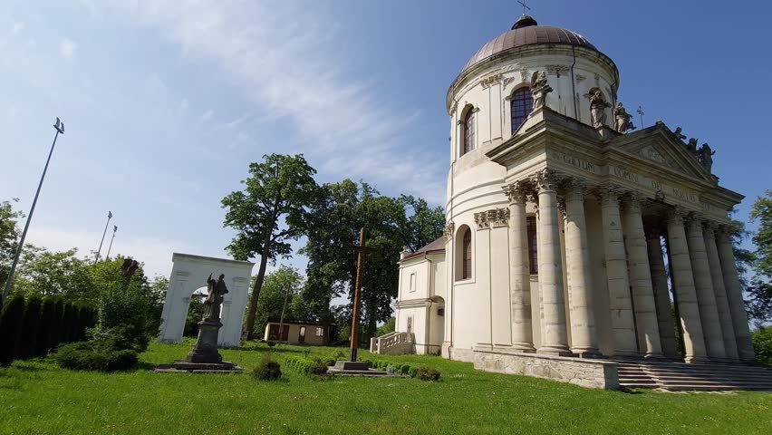 Baroque Roman Catholic church of St. Joseph built in the 18th, Pidhirtsi village, Ukraine. View in spring sunny day while panning
