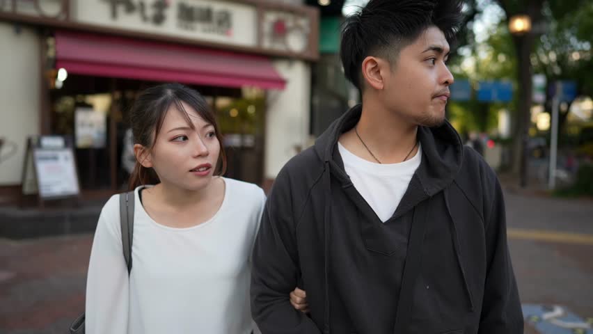 A young Japanese couple in their 20s spending time in the streets of Nagoya City, Aichi Prefecture