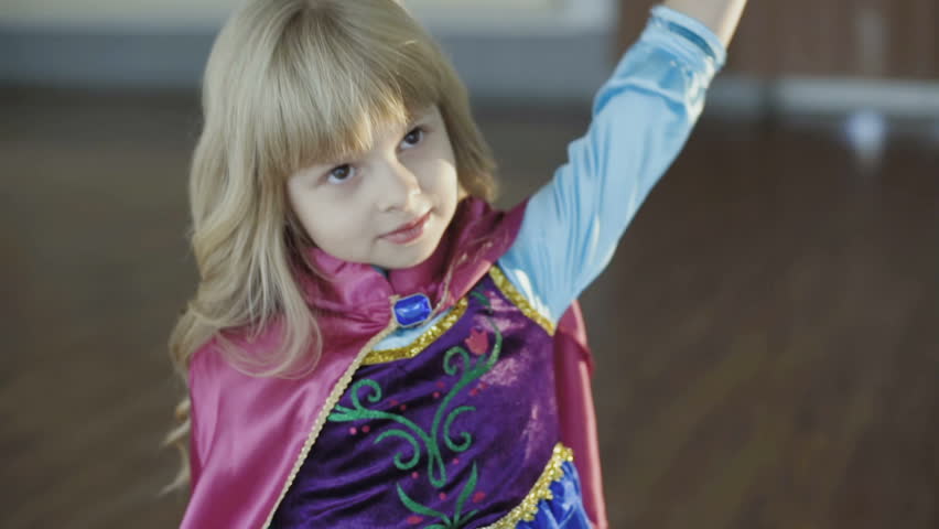 Portrait of little girl in costume of princess posing at camera. Full HD