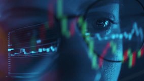 Trader wearing glasses is working on laptop computer. Screen with stock market charts and Bitcoin BTC or Ethereum ETH data analysis reflection. Broker trading online. Altcoins crypto currency trading - Powered by Shutterstock - Get 15% off with code: PIKWIZARD15