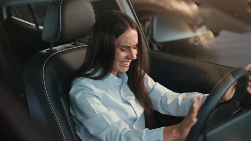 Sad upset stressed unhappy Caucasian female driver inside car in automobile woman girl lady stress anxiety worried depression despair problem trouble health failure relationship break up traffic jam Royalty-Free Stock Footage #3437845929