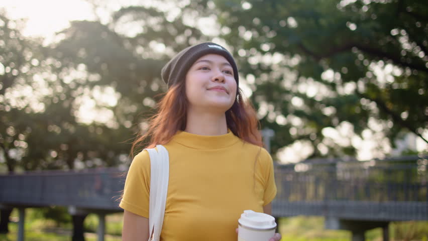 Go green Gen Z woman asia young people carrying eco tote mesh bag reuse walk in city nature tree public park save the earth planet world care. Reduce issues asian hope net zero waste the way forward. Royalty-Free Stock Footage #3437851351