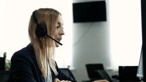 Caucasian positive woman in headphones communicates via video call center operator talks to customer on online conference webcam on computer talking using headset distance office chat e-learning
