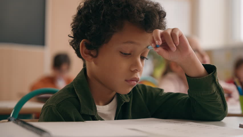 Smart African American guy boy think writing notes task exercise class lesson school learn write in copybook kid schoolboy son child pupil thinking learning studying primary education at table desk Royalty-Free Stock Footage #3437891807