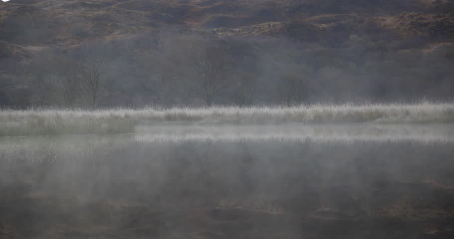 Winter scene, mist over the water and trees at lake in Wales - Nature and travel themed composition in Wales on a moody day, remote location