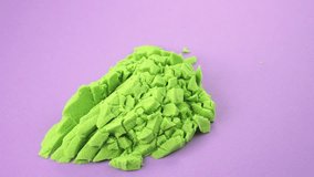 Kinetic sand cutting with a knife on a colored background. ASMR sounds. Very Satisfying and Relaxing Kinetic Sand ASMR video. Cutting anti stress macro close up colorful Kinetic Sand with a Knife.