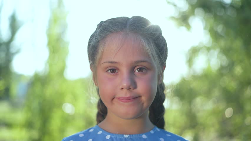 Happy family concept. happy child posing for camera in nature outdoors. baby's face close-up at sunset. cheerful kid looks at camera in nature and smiles. relaxation in forest park outdoors at sunset - Powered by Shutterstock - Get 15% off with code: PIKWIZARD15