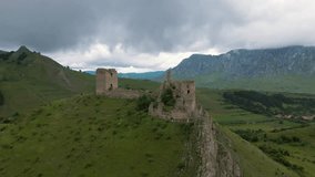 Aerial video of the ruins of Trascau medieval citadell in Romania. Footage was shoot from a drone while flying upwards and slowly lowering the camera angle for a cinematic shot of the ruins.