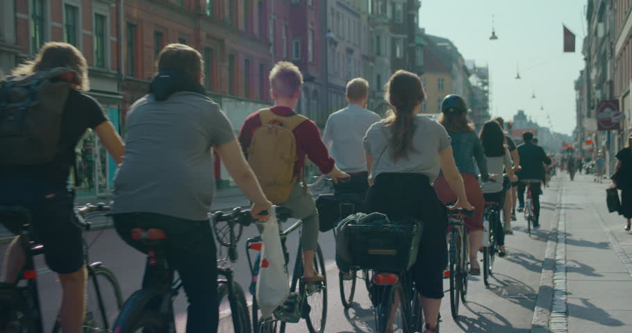 Busy cycling lane with cyclists in Copenhagen. Unrecognisable blurred cyclists riding away during commuter rush hour