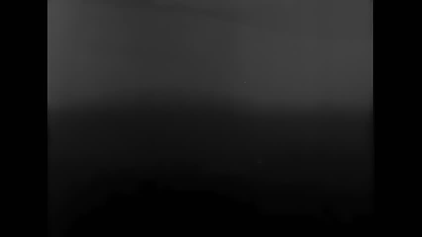 Kiska - 1943 - soldiers pile large packs and blanket rolls on the deck of a transport boat off the coast of kiska island, alaska.