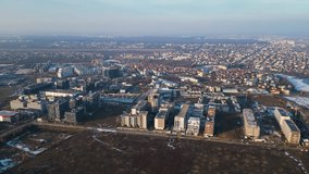Aerial drone footage of residential and office buildings of Pipera in Bucharest as seen from above. Flyover shot of the neighbourhoods of Voluntari and Pipera in winter filmed by a drone.