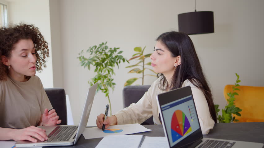 Professional indian teacher, manager or mentor helping latin student, new employee, teaching intern, explaining online job using laptop computer, talking, having teamwork discussion in office. Royalty-Free Stock Footage #3438152791