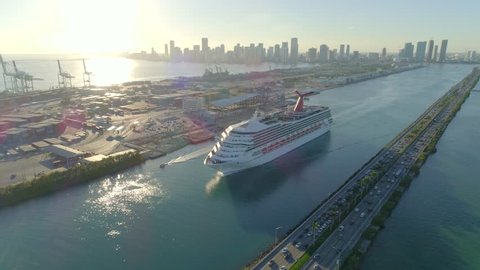 MIAMI BEACH, FL, USA - DECEMBER 29, 2017: Aerial drone video of a cruise ship departing Miami through Government Cut Inlet by Port Miami