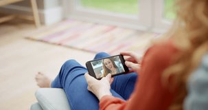 Woman, hands and video call with smartphone in home to relax, online and friends on screen or social media. Virtual, chat or person in conversation on sofa in lounge with communication on live stream