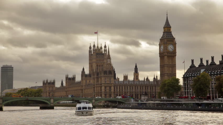Dark storm clouds behind Big Ben and Westminster palace, Thames river, flying